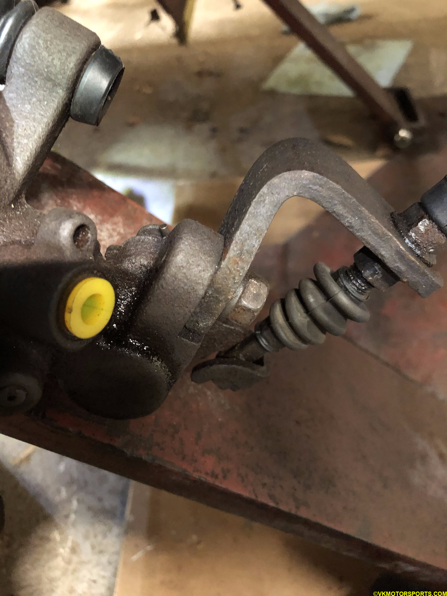 Loosen the nut on the old caliper's e-brake cable bracket