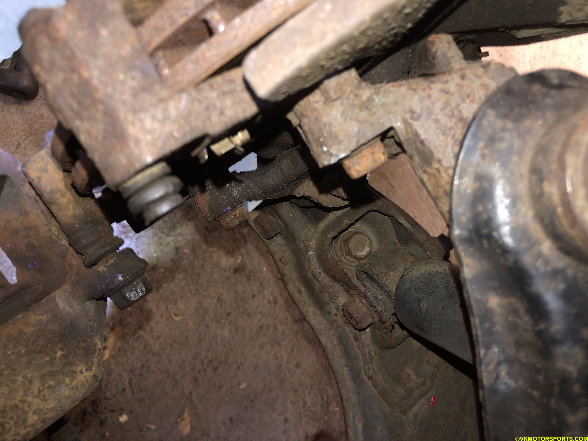 Upper nut view of the brake caliper bracket (leftmost)