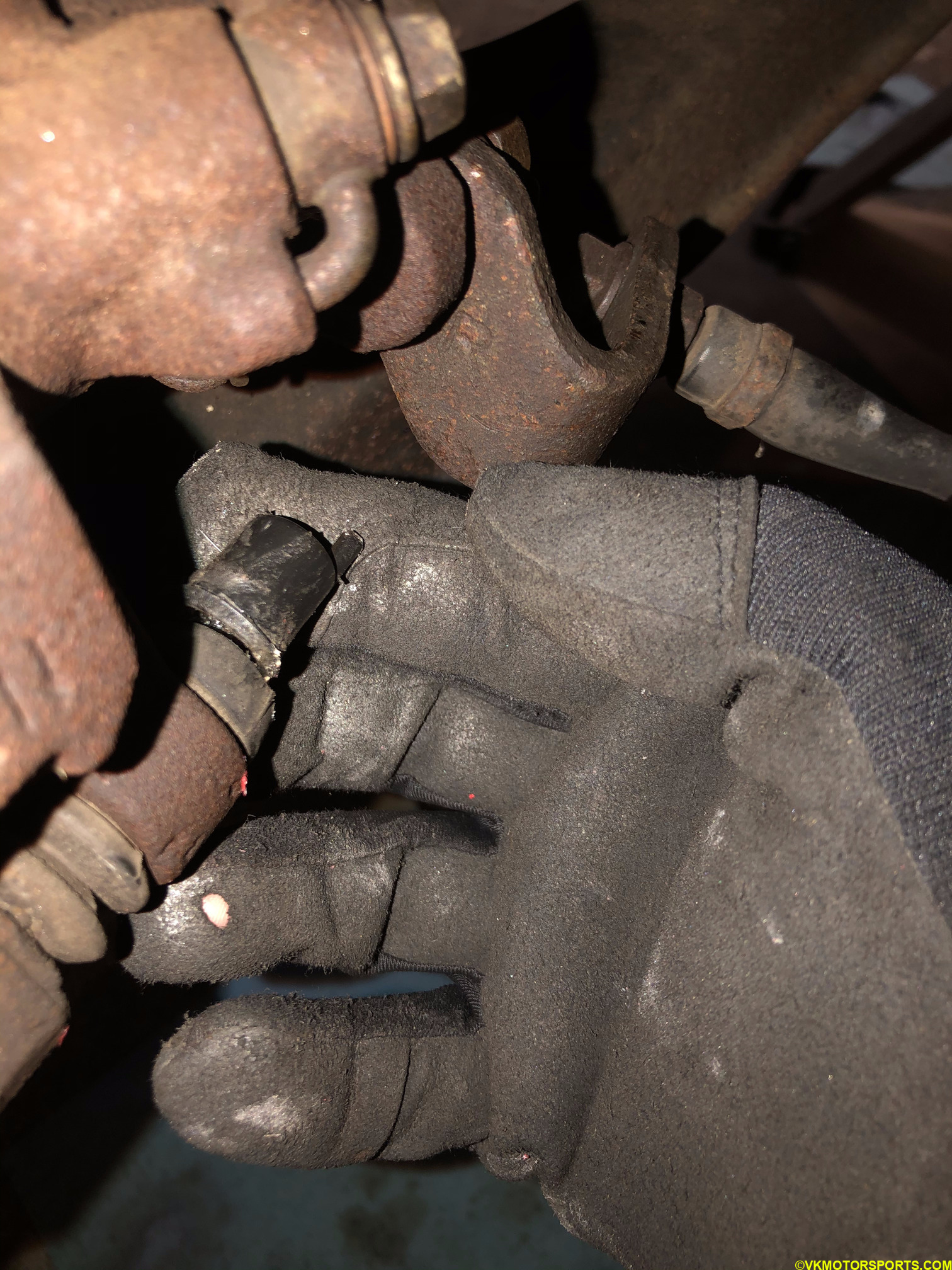 Remove the rubber cap on the rear facing side of the caliper