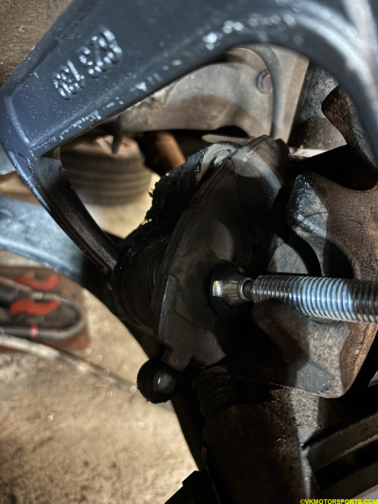 Figure 8. Front caliper cylinders being pressed in place with a C-clamp