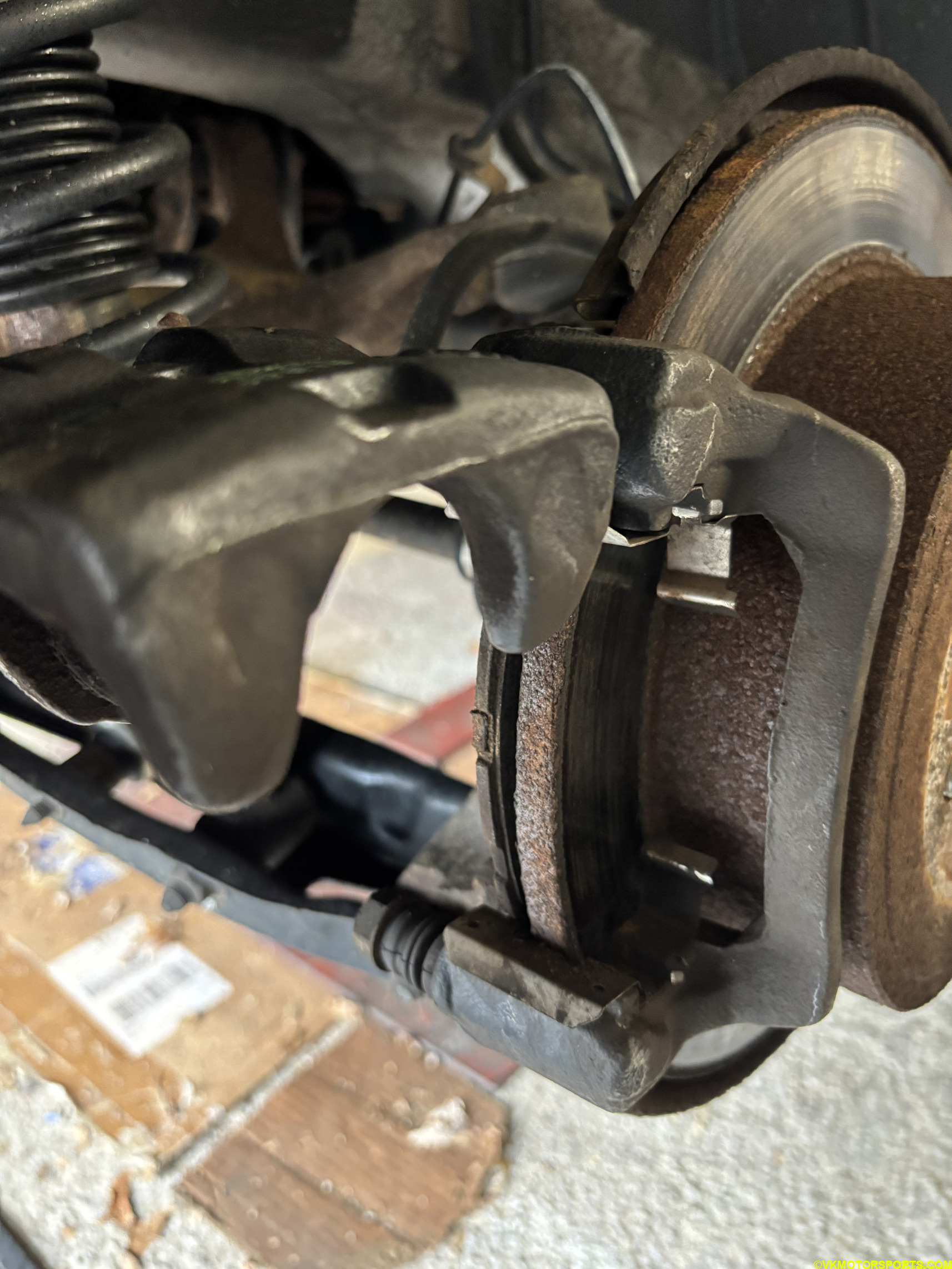 Figure 15. Flip the caliper upwards and remove the old brake pads