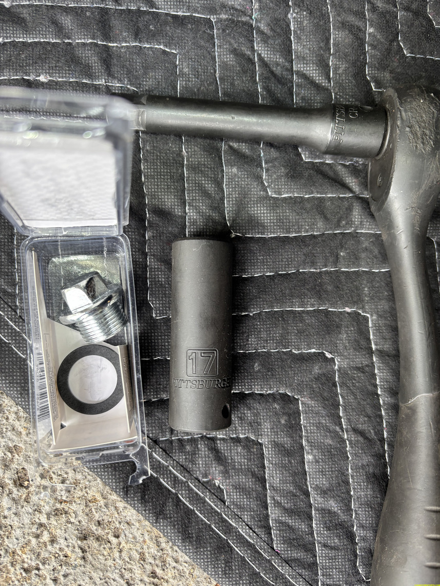 Figure 2. 17mm socket, socket wrench and new oil drain bolt/plug and washer